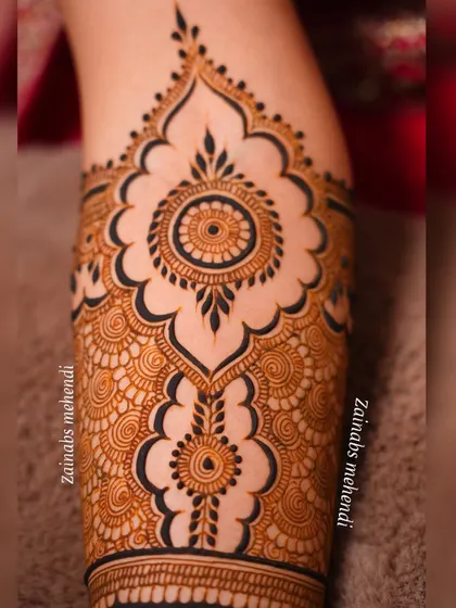 Another detailed shot of Arsha's forearm, showing the repeating mandala pattern.