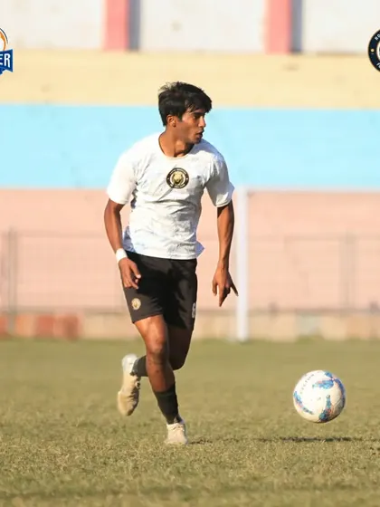 A player on the run, focused on the ball and the game ahead.