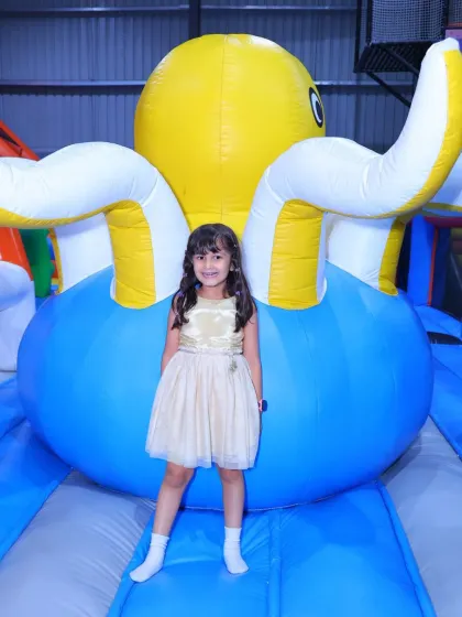 This little girl in a pretty dress stands proudly in front of our friendly inflatable octopus.