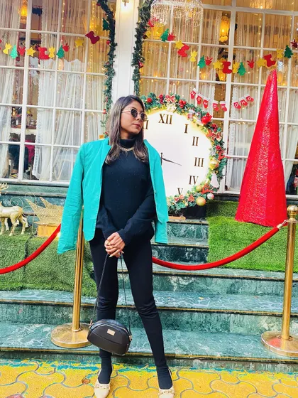 Making my vibes easier with this layered winter look. A bright turquoise jacket adds a pop of color to an all-black outfit, perfect for a festive Christmas-time outing.