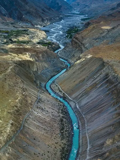 The Spiti River, a ribbon of turquoise flowing through the rugged Himalayan desert. Capturing this view required finding the perfect vantage point to show the river's journey through the vast canyon.