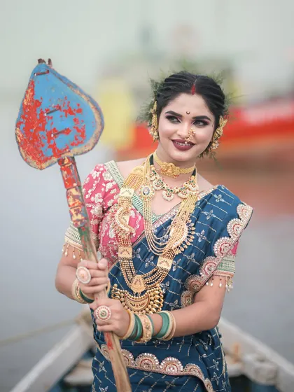 A close-up of the Koli look, showing the intricate details of the traditional gold jewellery and the unique hairstyle.