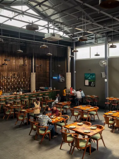 The space captured with patrons, showing how the design facilitates a lively and social atmosphere. The flexible seating and open layout create a welcoming environment, proving that good design is about how a space feels and functions.