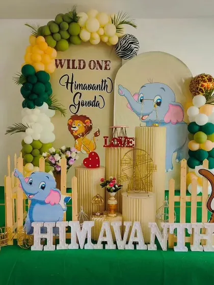 A "Wild One" jungle theme is one of our specialties. This setup for Himavanth's first birthday features cute animal cutouts, a lush green color palette, and a custom backdrop for a fun-filled celebration.