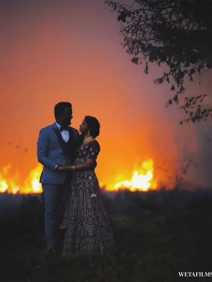 An intimate embrace with a stunning, fiery sunset behind the couple. This unplanned shot demonstrates our creative eye for turning any situation into a photo opportunity.
