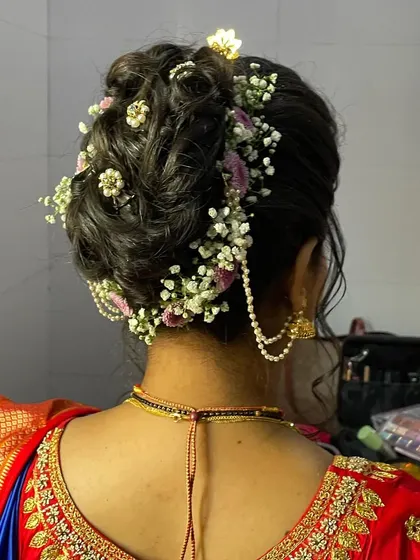 Another angle of the textured floral bun, showing how the flowers and pearl accessories are woven into the hair for a secure and beautiful finish.