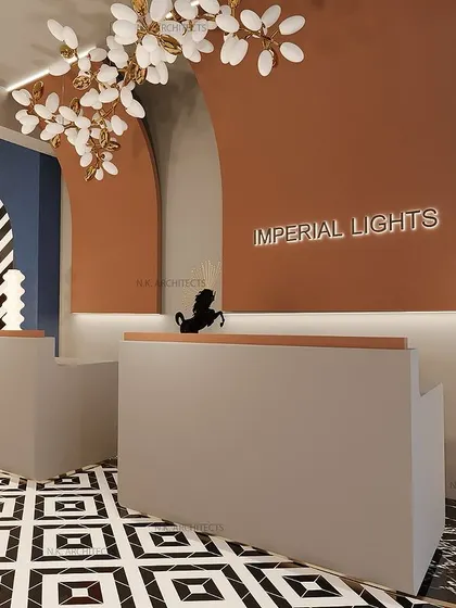 The reception desk for the Imperial Lights showroom. The design uses modern, clean lines and curved architectural elements, highlighted by elegant chandeliers.