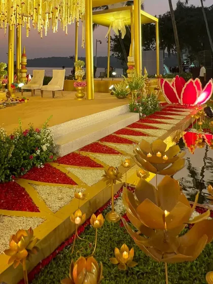 The aisle view of our 'Kamal Palace' mandap, with a pathway flanked by sculptural lotus props leading to the main ceremony area.