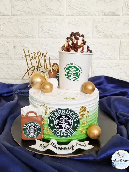 For the coffee lover in your life. This Starbucks themed cake features an edible coffee cup, the iconic green logo, and a little shopping bag, all made from fondant and buttercream.