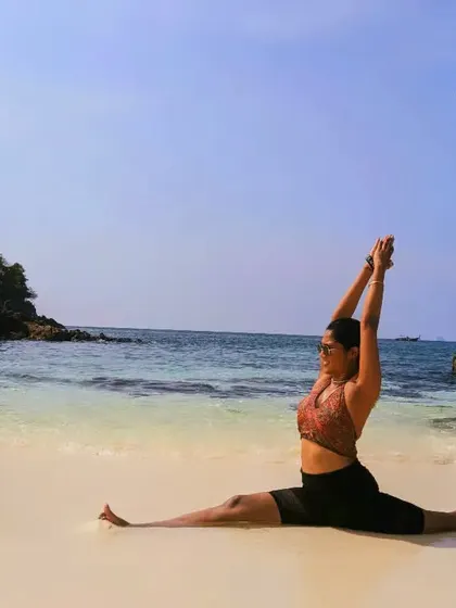 A joyful Hanumanasana (full split) on the beach. Yoga can be practiced anywhere, and the sand and sea make for a beautiful, grounding studio.