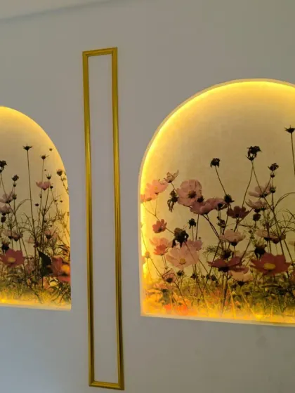 A beautiful installation of a floral mural inside two backlit wall arches, creating a stunning and luminous art piece.