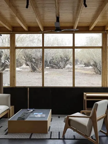 A duplicate of ID 52, showing the tranquil living area of the Postcard hotel. The design focuses on framing the view, making the landscape the primary feature of the guest experience.