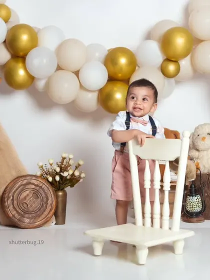 This little boy is standing tall and proud in our bohemian-themed studio with a teepee and balloon arch.