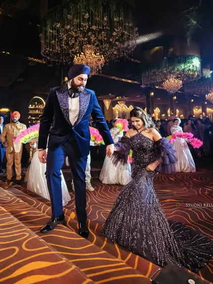 The couple makes a grand entrance at their reception, hand-in-hand.