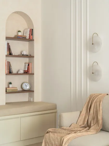 This inviting niche was designed to be a multi-purpose space. It serves as a reading nook, extra seating for guests, and includes hidden storage below the bench.