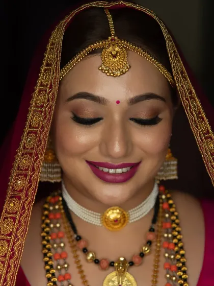 A close-up of the bride's flawless makeup. Her skin is glowing, and her smile is radiant.