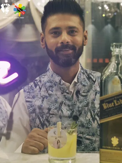 Our Senior Mixologist presents a custom cocktail next to a bottle of Johnnie Walker Blue Label. This image communicates premium quality, expertise, and personalized service.