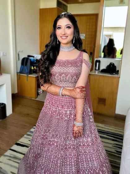 A full-length photo of Apeksha in her beautiful mauve lehenga, looking every bit the modern princess.