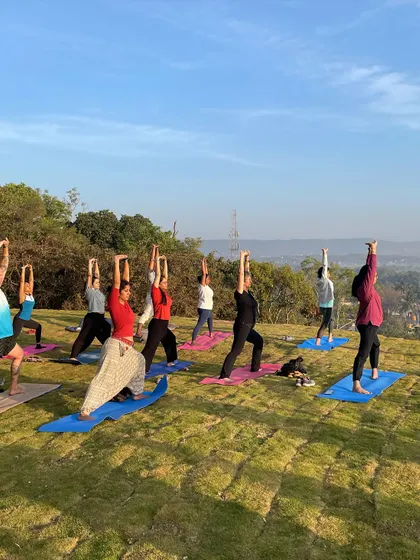 A wide shot of a yoga workshop overlooking a beautiful valley. Practicing yoga in nature connects us to the elements and deepens our sense of well-being.