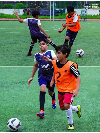 Players compete for the ball in a small-sided game, developing quick decision-making skills.