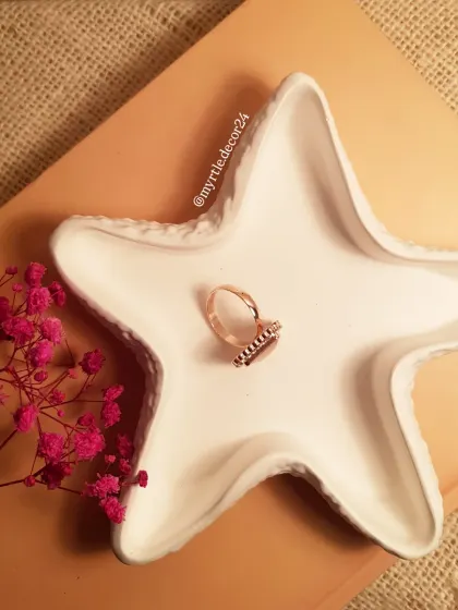 An overhead view of the white starfish trinket tray. Its simple shape and clean color make it a perfect, understated organizer.