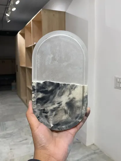Experimenting with resin and concrete to create unique surfaces. This sample trinket dish shows a beautiful marble-like effect that we plan to use for a larger piece.