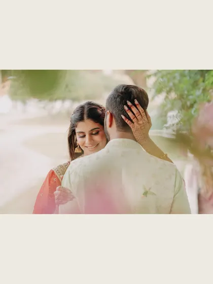 A tender moment captured from behind, focusing on the bride's happy expression and the groom's embrace. This intimate shot feels personal and heartfelt.