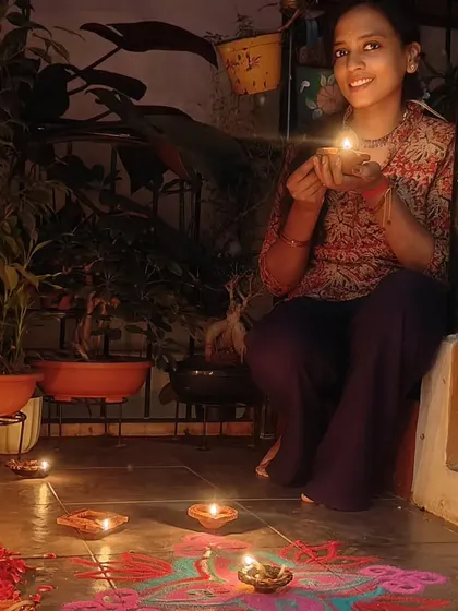 The warm glow of diyas on my festive rangoli. These moments of light and color inspire many of my creations.