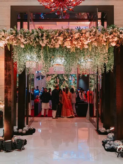 Crafting a grand entrance with cascading florals and dramatic lighting to ensure guests feel the magic from the moment they arrive.