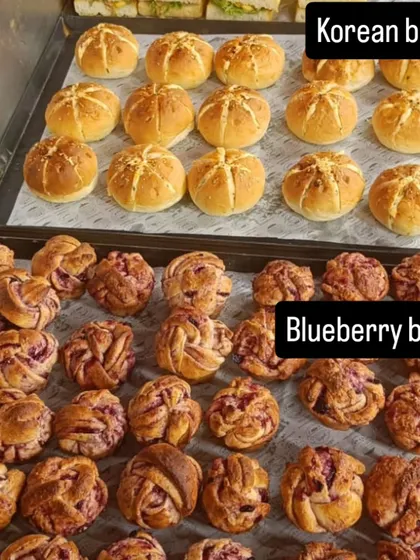 Korean buns and blueberry babka sit on separate trays in our sweet-and-savoury catering collection.