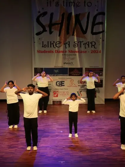 The group hits a clean, coordinated pose during their routine, showing great discipline and practice.