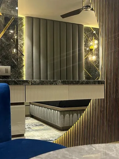 This vanity area in the Juhu home is a study in texture and reflection. I combined dark marble with gold inlay, fluted wood panels, and strategic lighting to create a glamorous and functional space.