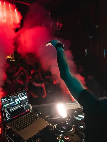 A view from behind the decks as red smoke fills the air. I love using smoke and lighting to create a moody, intense atmosphere.