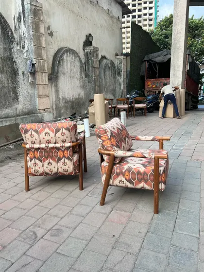 The chairs are pictured in an outdoor setting, ready for delivery.