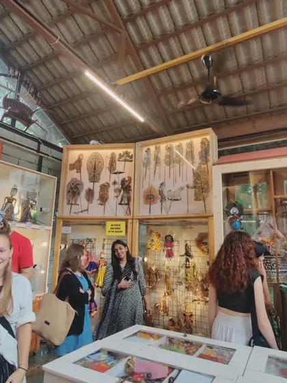 Students exploring the museum's collection of rod and shadow puppets. The displays are designed to be accessible, allowing visitors to get a close look at the craftsmanship of different puppet types.