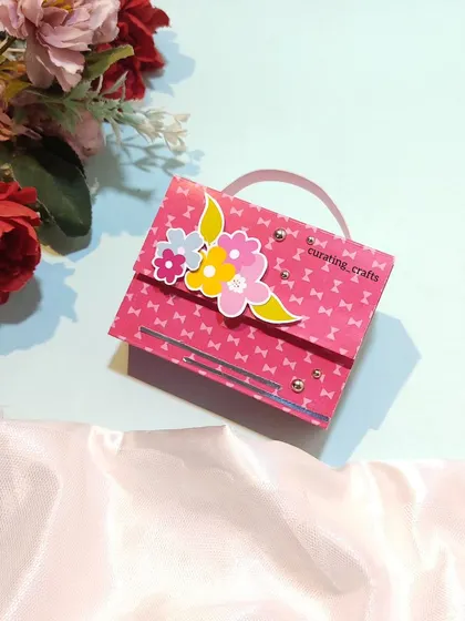 A small, purse-shaped mini album that was part of the fiancée's gift hamper.