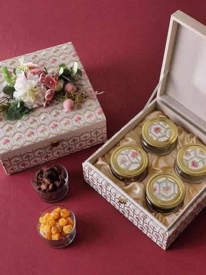 Our Kamal Box is a beautiful wooden box containing four jars of our festive treats: Rose Cashew, Mexican Trail Mix, Mini Butter Cookies, and Honey Choco Almonds.
