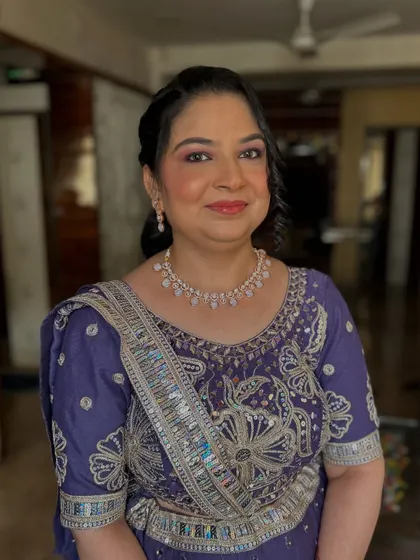 A beautiful makeover for a client in a purple lehenga. The makeup features a soft purple smokey eye and a radiant base.