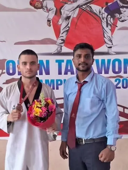 Posing with my student after he received his medal. His hard work and training really paid off.