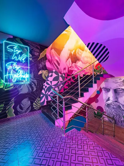 Why settle for a dull staircase? We collaborated with talented artists to turn this one into a canvas of color and pattern, complete with a neon sign, making the journey between floors an experience in itself.