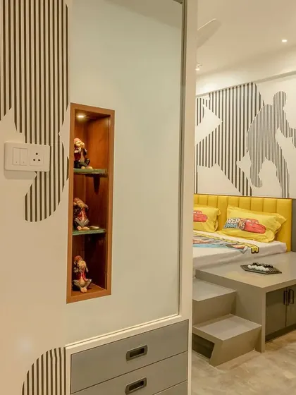 Abstract patterns on the wall and wardrobe create a dynamic and sporty theme in this teenager's bedroom.