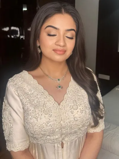 A serene shot with eyes closed, showcasing the soft, blended eyeshadow and flawless base.
