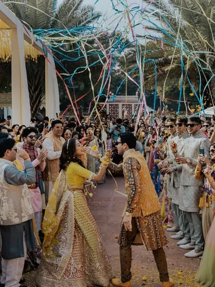 The couple's grand entrance was celebrated with a shower of colorful ribbons, creating a festive and dynamic moment for everyone.