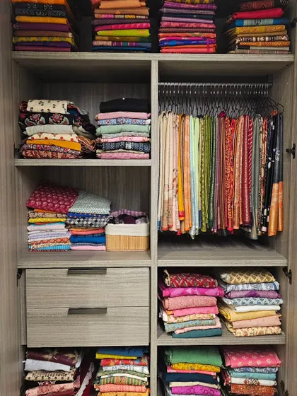 You don't always need fancy organizers. Here, we simply rearranged items across three wardrobes to create a logical flow, making the space work for the client, not against her.