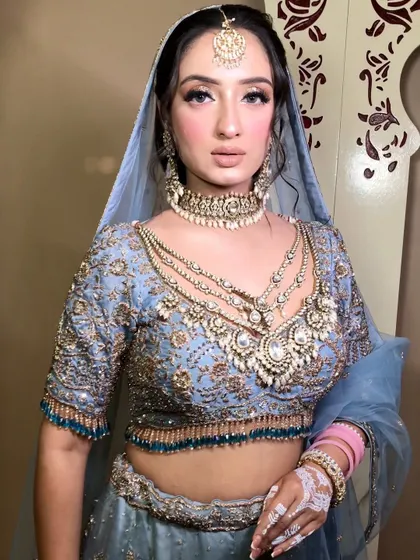A close-up portrait showing the intricate details of the jewelry and the flawless finish of the makeup.