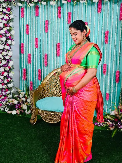 The bright, happy colors of this Kanchipuram silk saree are perfect for celebrating the upcoming arrival of a new family member.