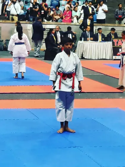A young competitor stands ready on the tatami mat, focused and prepared for his kata performance at the Independence Cup.
