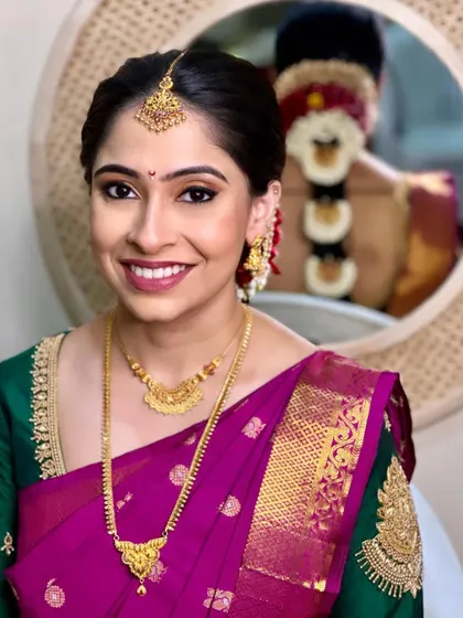 A happy moment with my Brahmin bride. The makeup is kept clean and radiant, with a focus on her eyes, and the look is completed with a traditional floral braid.