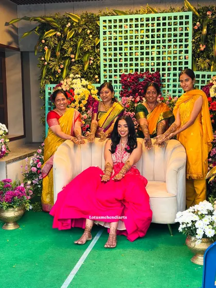 The bride surrounded by the lovely ladies of her family, all showing off their beautiful mehendi. A picture of pure joy.
