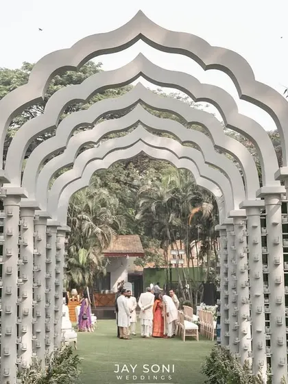A closer look through the repeating arches of the all-white walkway, creating a stunning tunnel effect that draws the eye forward and builds excitement for what lies beyond.